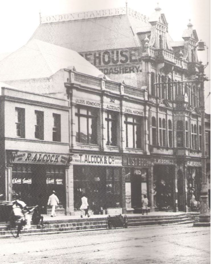 West Street, Durban, with the hardware store Alcock & Co, List Brothers and D. McDonald in the London Chambers Building